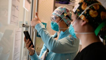 Doctor on phone with thumbs up.