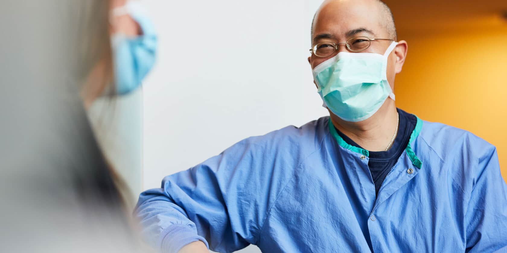 Man with mask laughing.