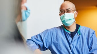 Man with mask laughing.